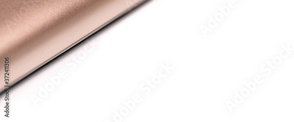 Fototapeta Rose gold colored metal smartphone case, closeup macro detail forming diagonal line with space for text right, abstract technology background