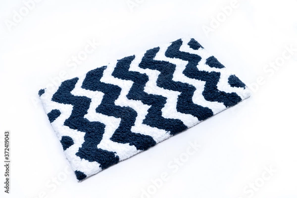 Fototapeta Flat lay, black and white color with zig zag pattern of microfiber bath mat isolated on white background