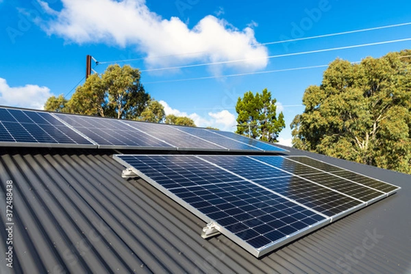 Fototapeta New solar panels installed on metal sheet roof of the house in South Australia