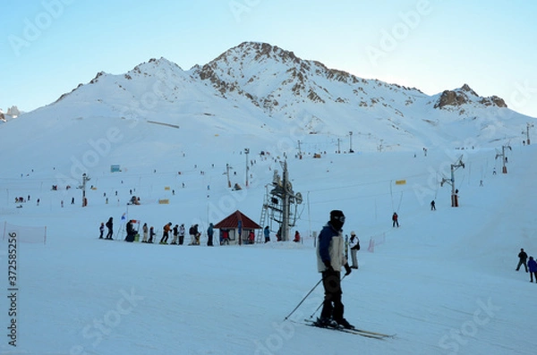 Obraz Man skiing in the Andes mountains with a line of lifts in the background