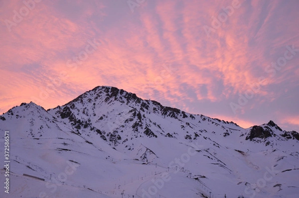 Obraz colorful dusk with light clouds and snowy mountains in the foreground