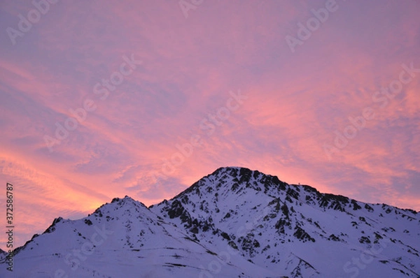 Obraz colorful dusk with light clouds and snowy mountains in the foreground
