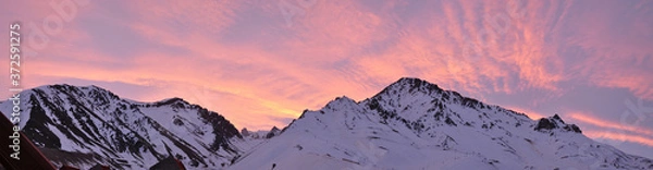 Obraz colorful dusk with light clouds and snowy mountains in the foreground