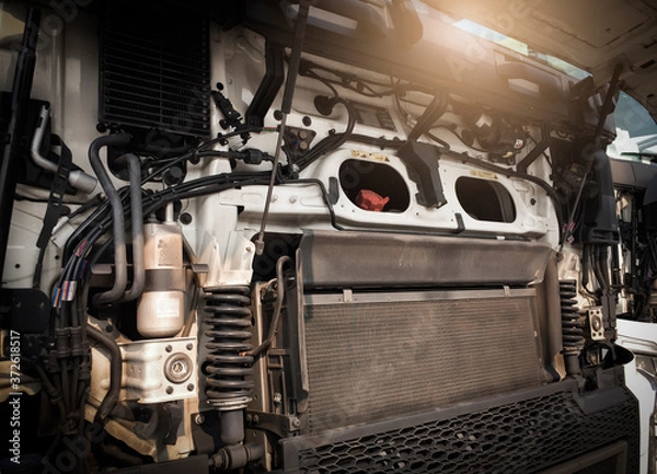 Fototapeta Front engine with open hood fixing and repairing big heavy semi truck.