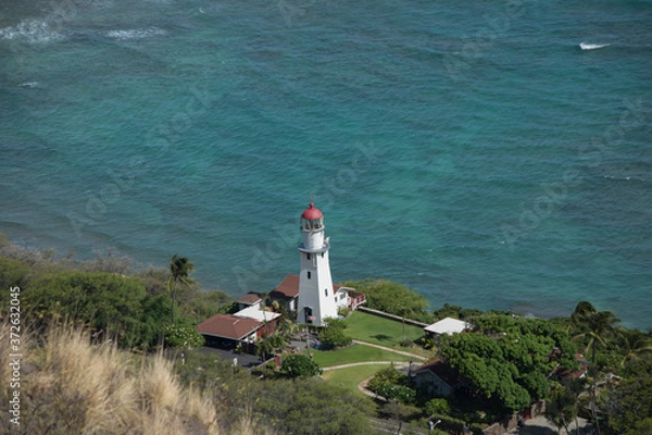 Obraz Tropical island Light house in hawaii below diamond head crater off the coast of Waikiki Oahu 