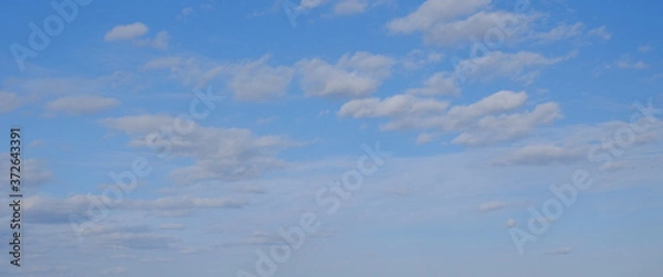 Obraz Blue spring sky with white clouds. Beautiful background.