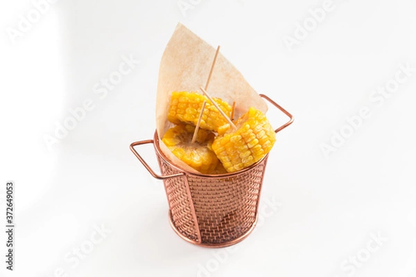 Fototapeta Isolated cooked cut corn in a copper bucket