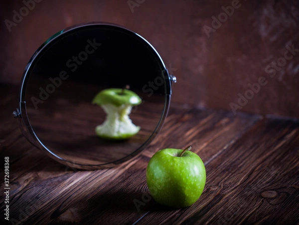 Fototapeta Apple reflecting in the mirror surrealistic picture abstract vision , concept you are not you how others see you how you see yourself
