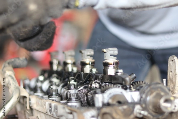 Fototapeta The mechanic is checking the engine.