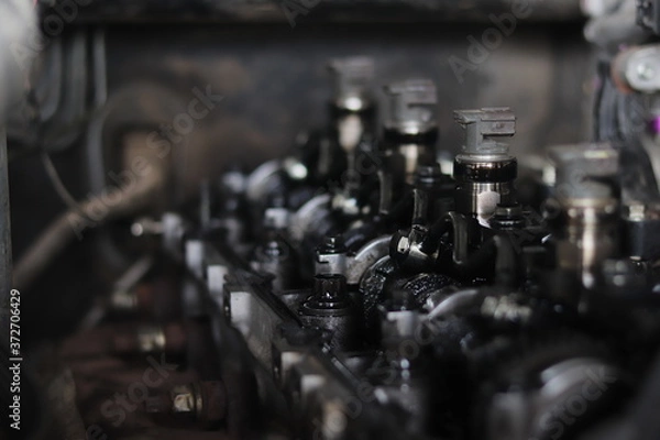 Fototapeta The mechanic is checking the engine.