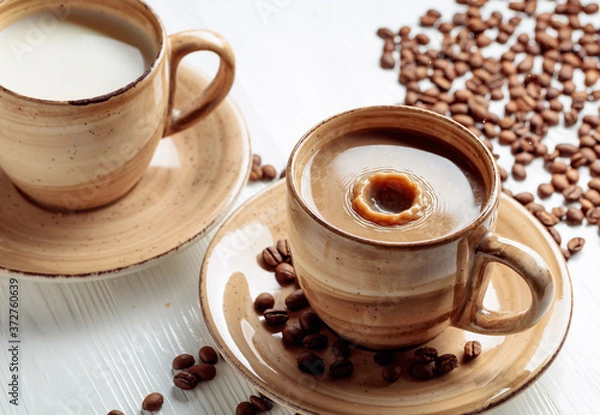 Fototapeta Latte and coffee beans on a white wooden table.