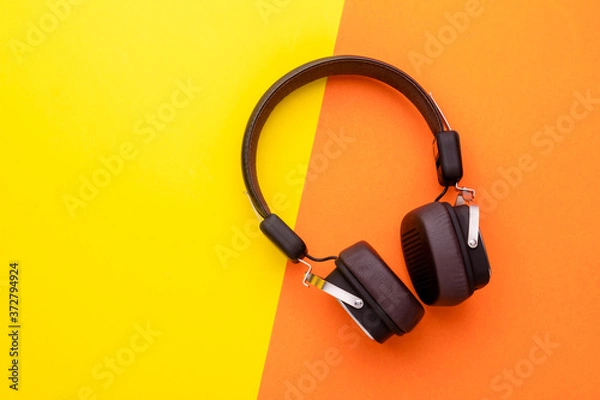 Fototapeta Black Headphone or Headset on bright color background. Copy space for text or design