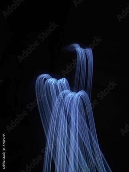 Fototapeta light painting Photography, long exposure, ripple curve and circle against black background
