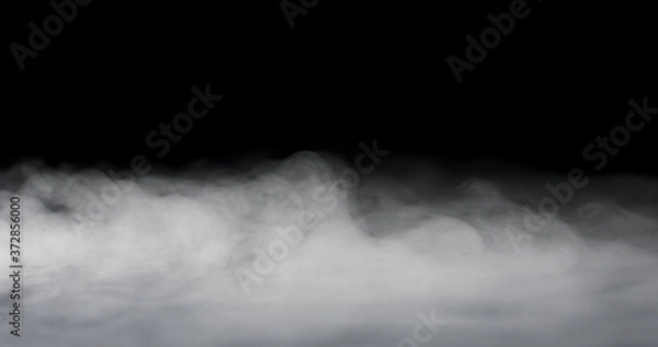 Fototapeta heavy fog passing across a black background.