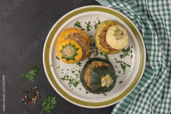 Fototapeta Vegetarian stuffed round zucchinis with vegetables, top view, flat lay. Ready to eat.