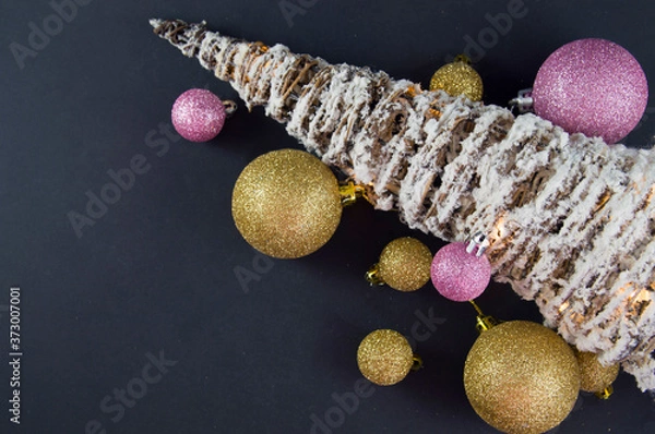 Obraz christmas tree with colorful toys on a black background
