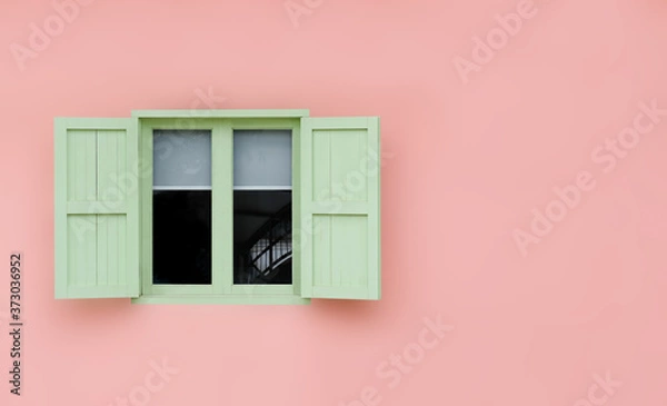 Fototapeta Vintage opened green mint shutters and wooden windows isolated on pink background with copy space and clipping path.