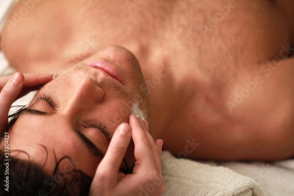 Fototapeta Young man relaxing during a massage with eyes close