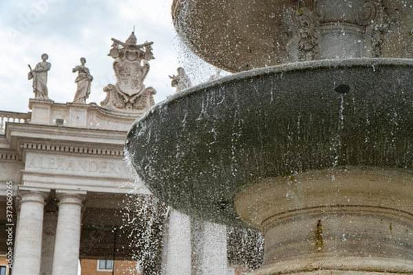 Fototapeta Piazza San Pietro in Rome, fountain with the dome and a detail of the church.