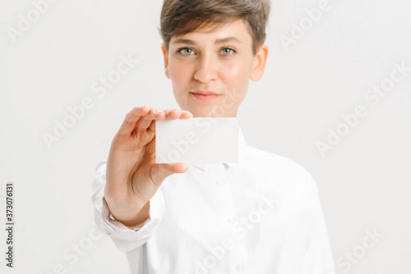 Fototapeta  close-up portrait of a young businesswoman with Blank Business Card
