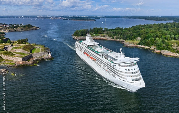 Fototapeta The cruise ferry is departing from Helsinki and moving near the Suomenlinna island, Finland.