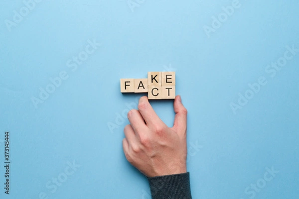 Fototapeta Concept of fact and fakes on wooden cubes