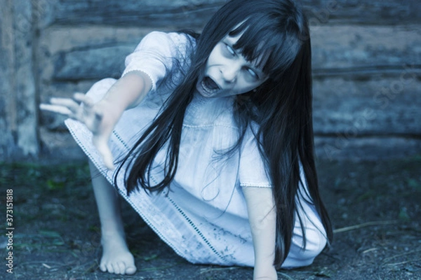 Fototapeta Scary ghost girl pulling with her hand  and crept on the ground
