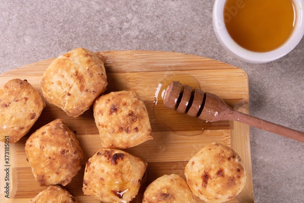 Obraz typical Brazilian snack: tapioca dumpling with honey