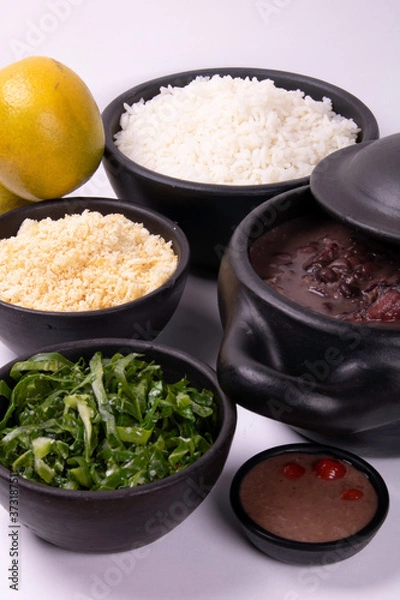 Obraz complete feijoada with rice, beans, cabbage, farofa, orange and pepper