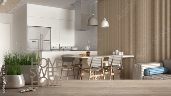 Fototapeta Wooden table, desk or shelf with potted grass plant, house keys and 3D letters home sweet home, over classic kitchen and lounge, architecture interior design, copy space background