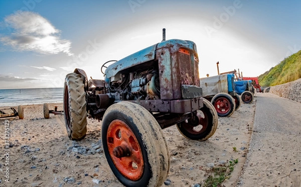 Fototapeta Close up and fisheye view of tractor on Cromer beach on the North Norfolk coast