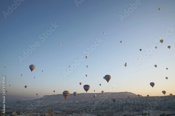 Obraz Hot air balloon flying over rock landscape at Cappadocia Turkey