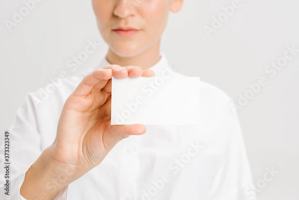 Fototapeta  close-up portrait of a young businesswoman with Blank Business Card