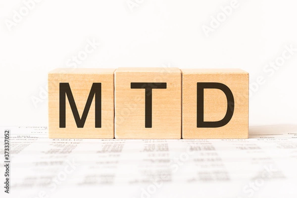 Fototapeta Word MTD - Month To Date acronym. Wooden small cubes with letters isolated on white background with copy space available. Business Concept image.