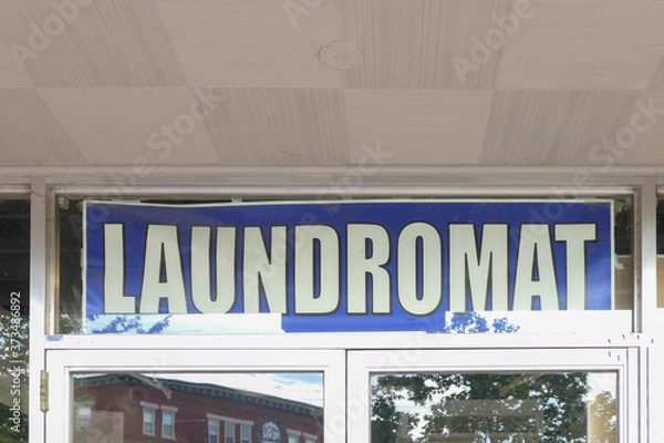 Fototapeta Laundromat sign in a window