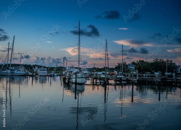 Fototapeta Predawn at the dock with sailboats on calm waters