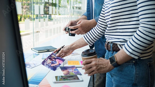 Fototapeta Advertising agency designer creative start-up team discussing ideas in office. 
