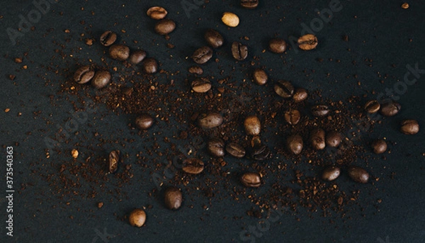 Obraz Coffee beans and ground coffee beans on black background