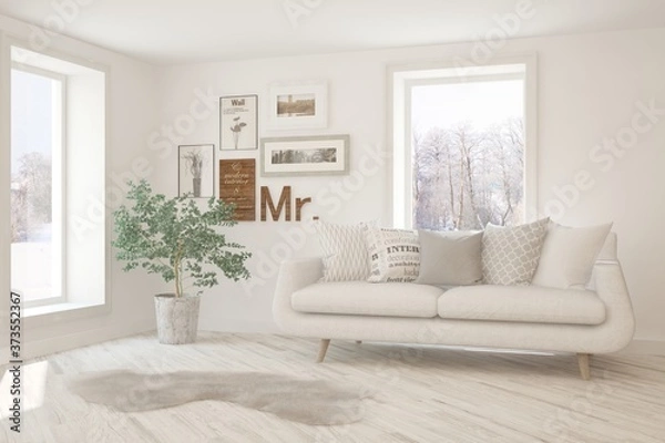 Fototapeta White stylish minimalist room with sofa and winter landscape in window. Scandinavian interior design. 3D illustration
