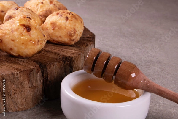 Obraz typical Brazilian snack: tapioca dumpling with honey