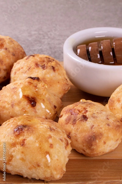 Obraz typical Brazilian snack: tapioca dumpling with honey