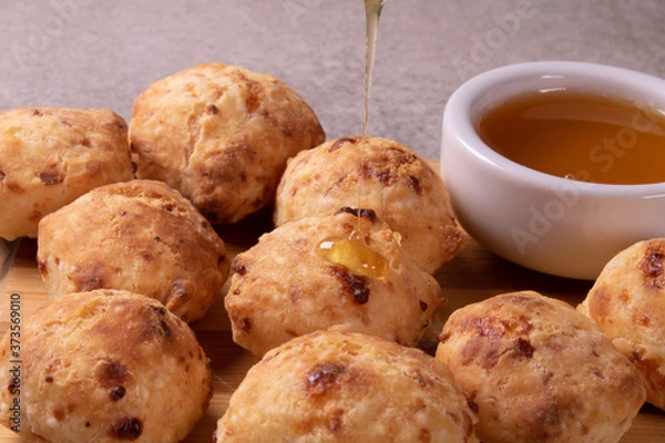 Obraz typical Brazilian snack: tapioca dumpling with honey