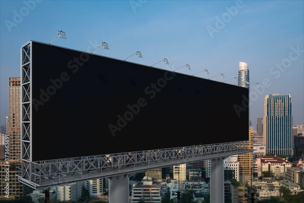 Fototapeta Blank black road billboard with Bangkok cityscape background at sunset. Street advertising poster, mock up, 3D rendering. Side view. The concept of marketing communication to promote or sell idea.
