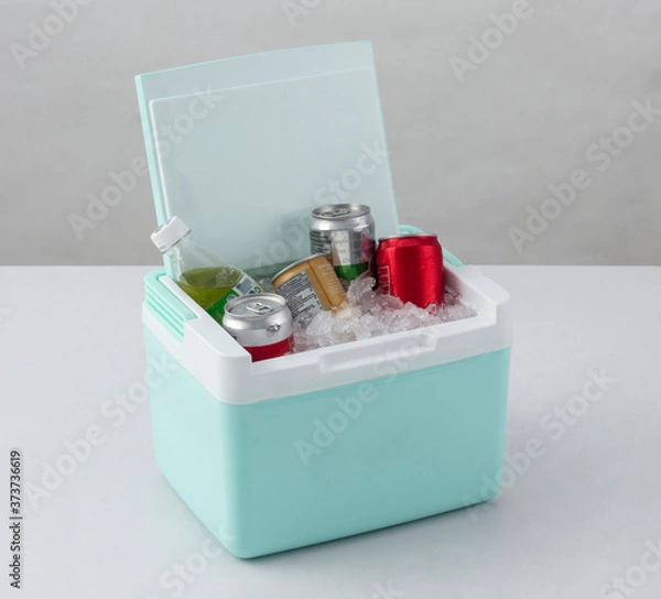 Fototapeta Opened green cooling box with bottles of beverage and ice isolated on white