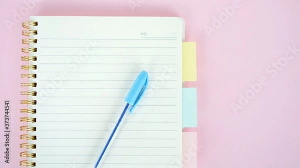 Fototapeta Open blank journal on pink background. Concept for creative person planning. Back to school. Top view, flat lay, mockup