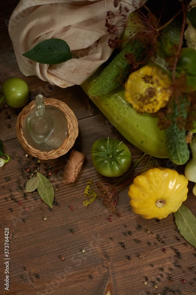 Fototapeta 
Fresh vegetables, peppercorns and a small glass jar on a wooden background flat lay.