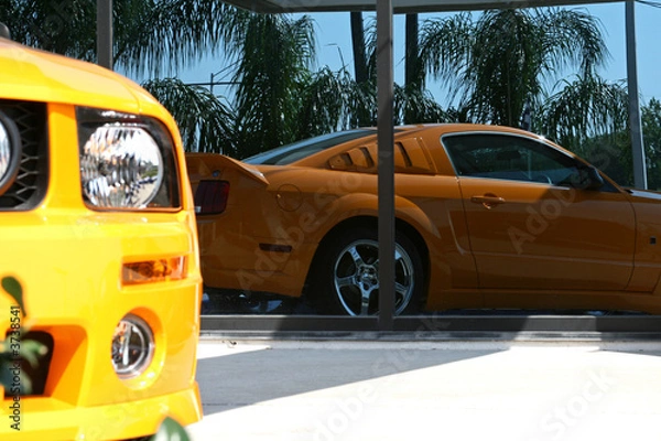 Obraz reflection of an orange american muscle car
