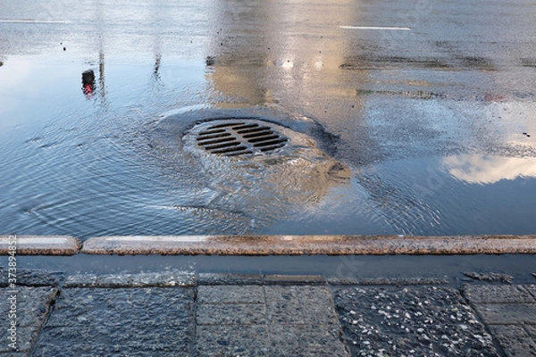 Obraz drainage hole after rain. For flood protection within the residential area of ​​the urban community.