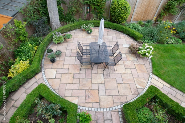 Fototapeta circular garden patio with freshly jet washed paving stones