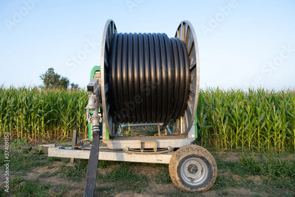 Fototapeta irrigation reel by the side of a maize field in france
